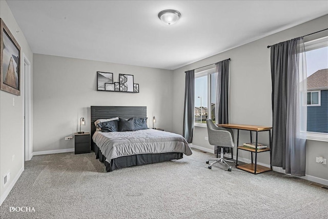 carpeted bedroom featuring visible vents and baseboards