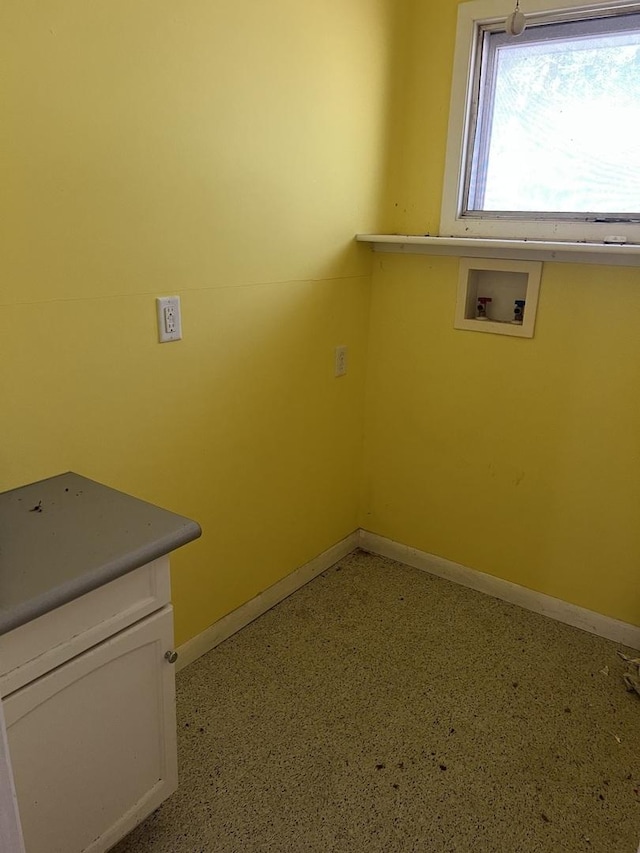 laundry room featuring hookup for a washing machine, cabinet space, and baseboards