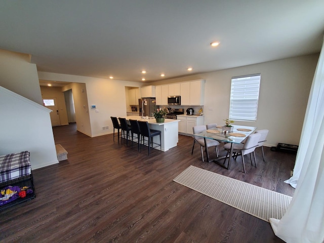 dining room with dark wood-style floors, stairway, baseboards, and recessed lighting