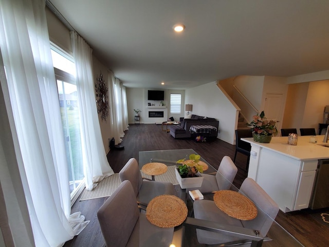 dining space featuring dark wood-type flooring, stairs, and recessed lighting