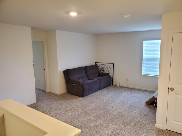 sitting room featuring carpet floors and baseboards