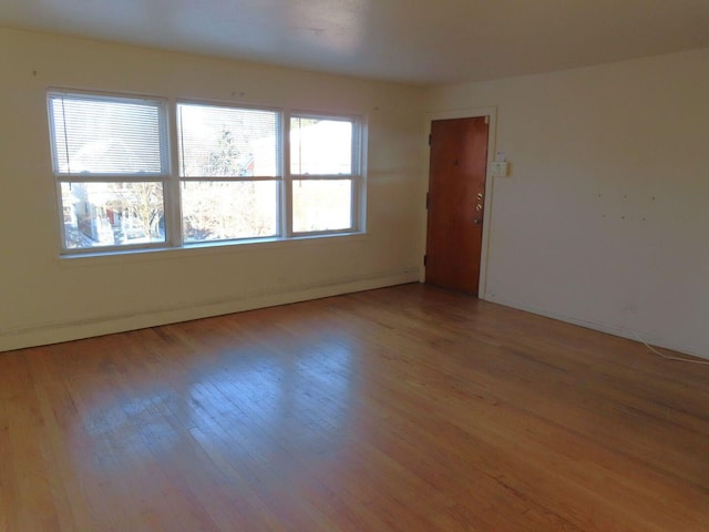 spare room featuring light wood-style floors