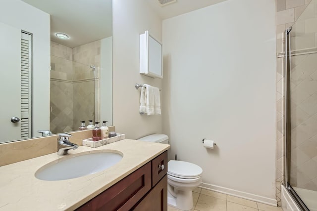 full bath featuring toilet, a stall shower, vanity, baseboards, and tile patterned floors