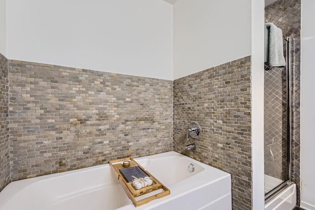 bathroom with a stall shower, tile walls, and a bath