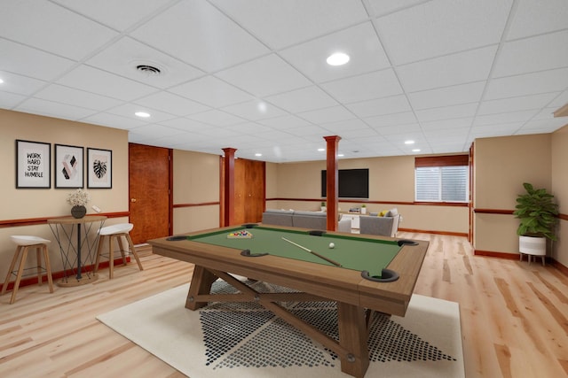 recreation room with a paneled ceiling, visible vents, and wood finished floors