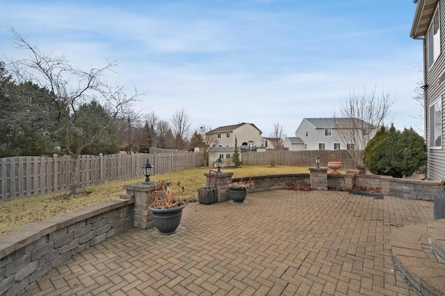 view of patio / terrace with a fenced backyard and a residential view