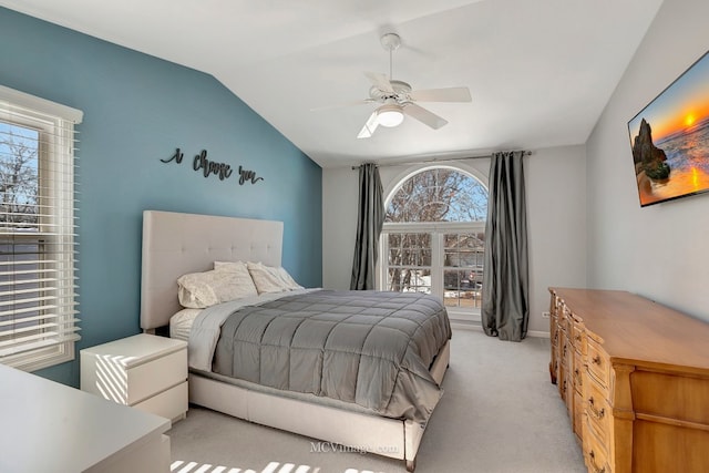 bedroom featuring light carpet, ceiling fan, and vaulted ceiling