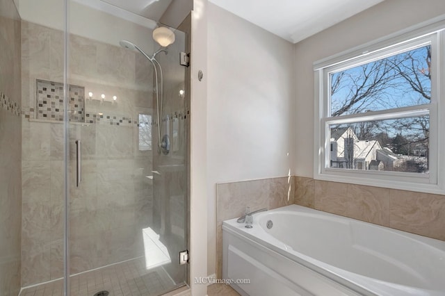 bathroom featuring a stall shower and a garden tub