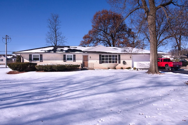 single story home featuring a garage and brick siding