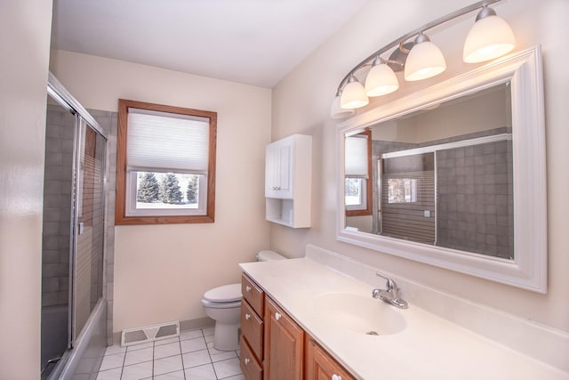 bathroom with visible vents, toilet, vanity, baseboards, and tile patterned floors