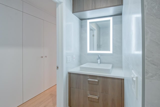 bathroom with vanity and wood finished floors