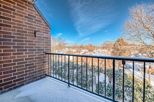 view of snow covered back of property