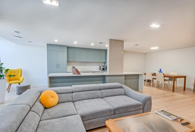 living room with light wood-type flooring, baseboards, visible vents, and recessed lighting