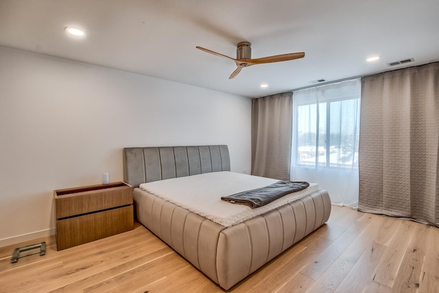 bedroom with light wood-type flooring, visible vents, and recessed lighting