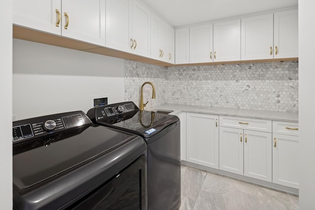 180 E Pearson St Unit 4606, Chicago, IL 60611 - laundry area with cabinet space, marble finish floor, a sink, and washing machine and clothes dryer