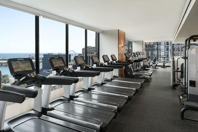 180 E Pearson St Unit 4606, Chicago, IL 60611 - gym featuring floor to ceiling windows and a water view