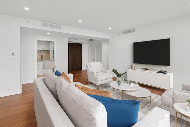 180 E Pearson St Unit 4606, Chicago, IL 60611 - living room featuring visible vents, wood finished floors, and recessed lighting