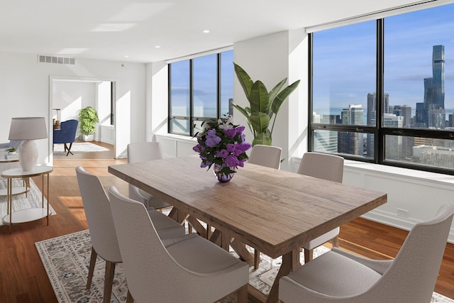 180 E Pearson St Unit 4606, Chicago, IL 60611 - dining room featuring visible vents, a city view, wood finished floors, and recessed lighting