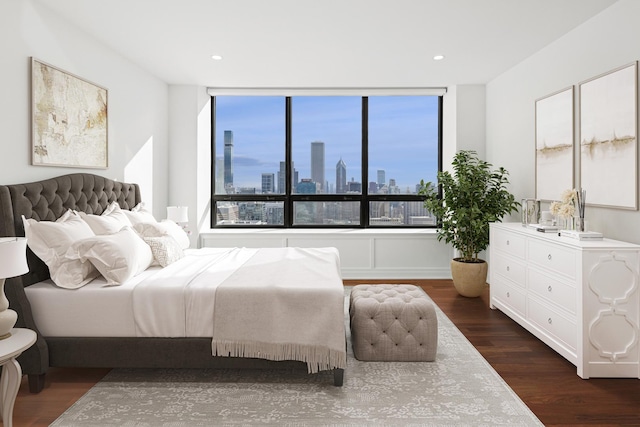 180 E Pearson St Unit 4606, Chicago, IL 60611 - bedroom featuring dark wood finished floors, a city view, and recessed lighting