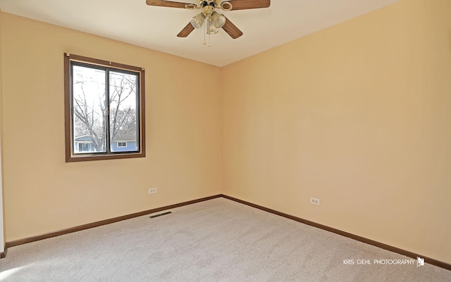 unfurnished room with visible vents, carpet floors, baseboards, and a ceiling fan