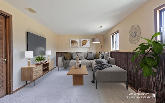 living room with visible vents and light colored carpet