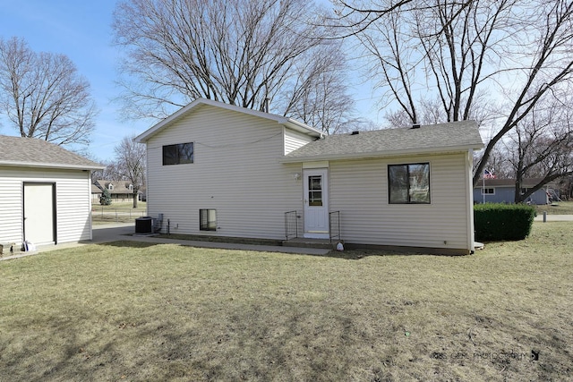 back of property with cooling unit and a lawn