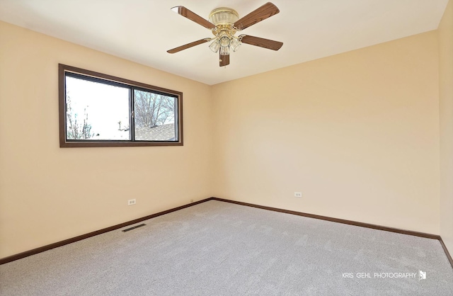 carpeted empty room featuring a ceiling fan, baseboards, and visible vents