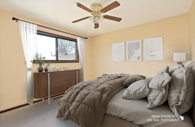 carpeted bedroom featuring a ceiling fan and baseboards