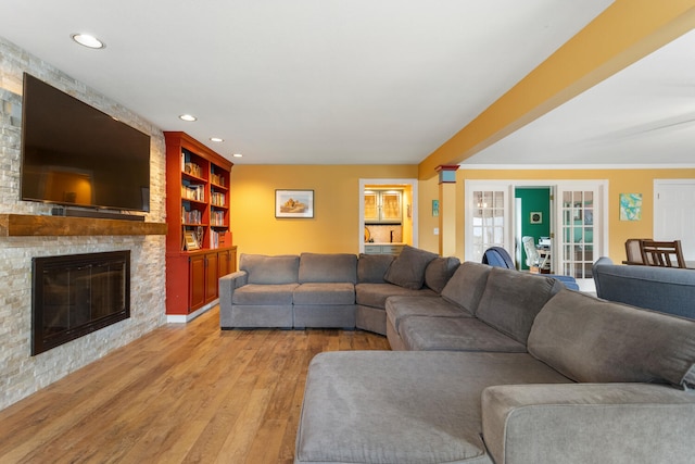 living area featuring light wood-style floors, a fireplace, and recessed lighting