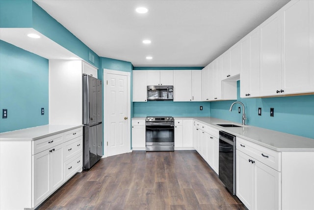 kitchen with recessed lighting, dark wood-type flooring, a sink, light countertops, and appliances with stainless steel finishes