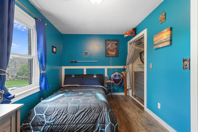 bedroom with wood finished floors and baseboards