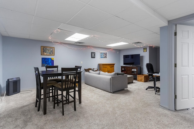 dining space featuring a drop ceiling, carpet, and visible vents