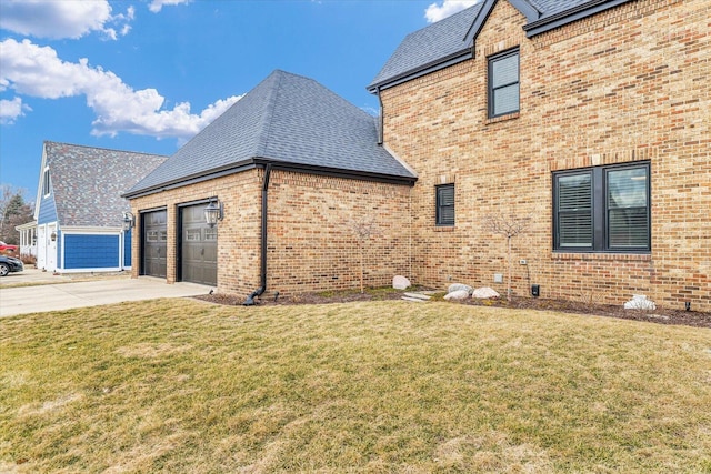 view of side of property with a garage, a shingled roof, a lawn, concrete driveway, and brick siding