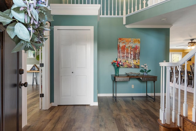 entryway featuring crown molding, stairway, a ceiling fan, wood finished floors, and baseboards