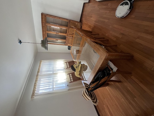 interior space featuring wood finished floors and wooden walls