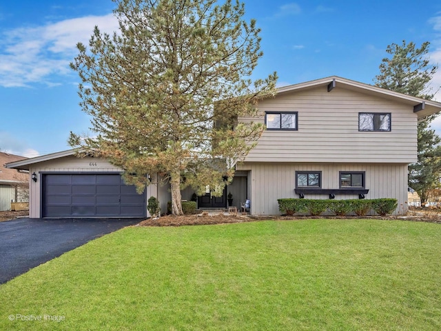 view of front facade with aphalt driveway, an attached garage, and a front lawn