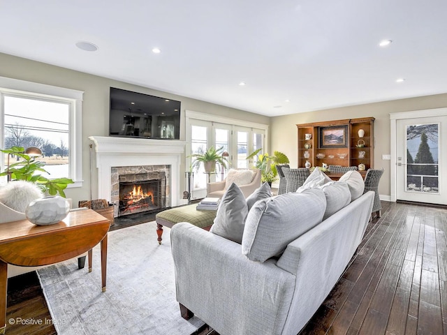 living area with a fireplace, baseboards, dark wood finished floors, and recessed lighting