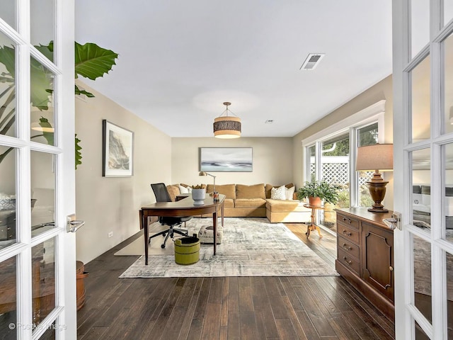 office area with visible vents and dark wood-type flooring