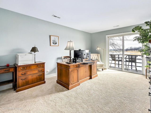 home office with carpet, visible vents, and baseboards