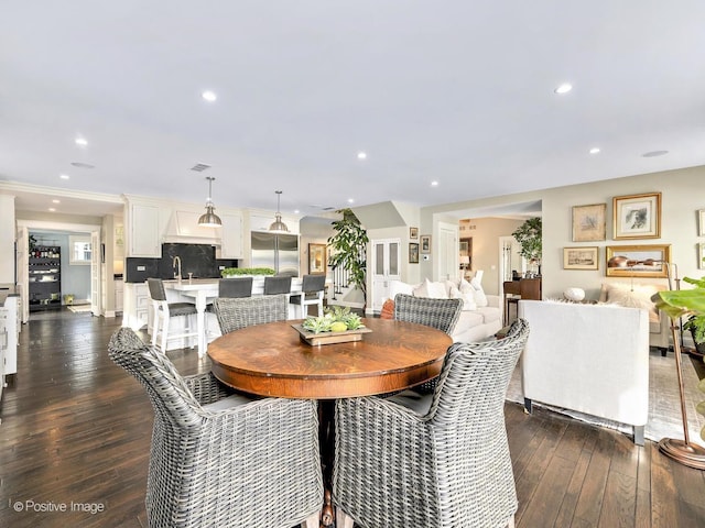 dining area featuring dark wood finished floors and recessed lighting