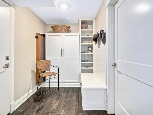 mudroom with dark wood-style floors and baseboards