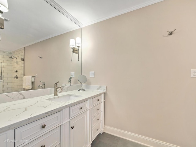 full bath featuring baseboards, tiled shower, tile patterned flooring, crown molding, and vanity