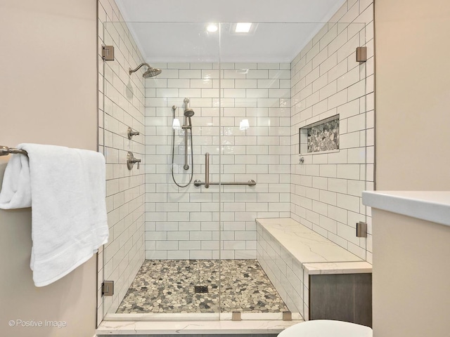 full bath with a stall shower and crown molding