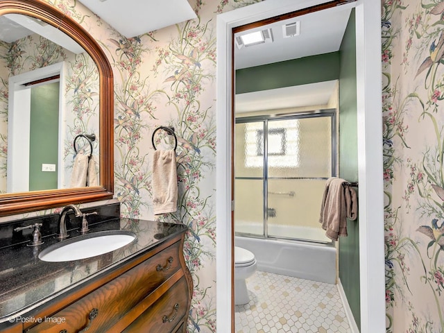 full bathroom featuring wallpapered walls, toilet, tile patterned floors, combined bath / shower with glass door, and vanity