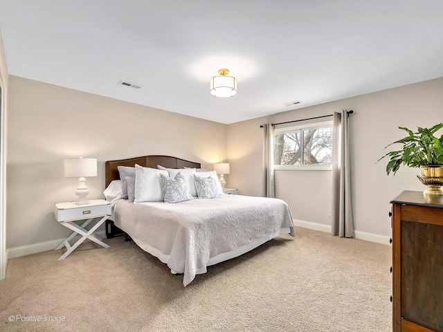 bedroom featuring light carpet, visible vents, and baseboards