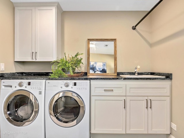 laundry area featuring independent washer and dryer, a sink, and cabinet space