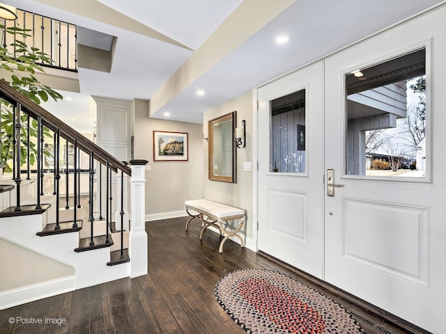 entrance foyer featuring stairs, baseboards, dark wood-type flooring, and recessed lighting