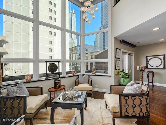 sunroom / solarium featuring a chandelier and a view of city