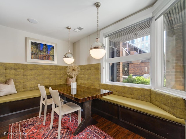 dining space with wood finished floors and visible vents