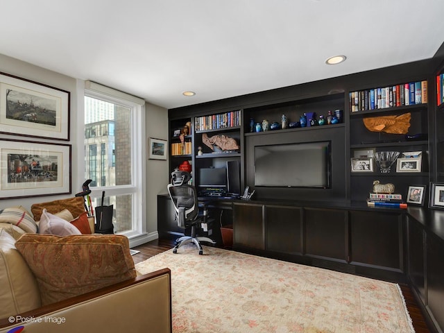 office with dark wood-style flooring and recessed lighting